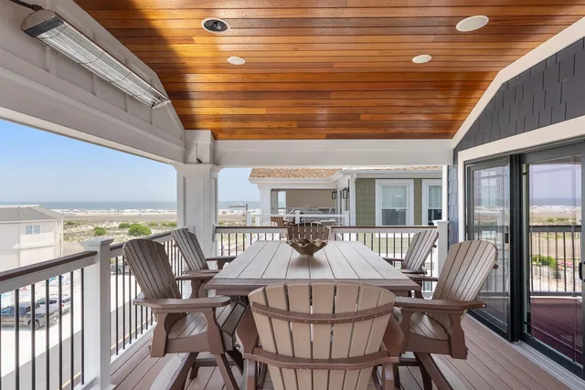 a view of a patio with table and chairs