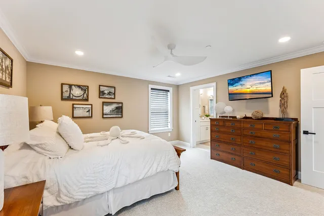 a bedroom with a large bed and a flat screen tv