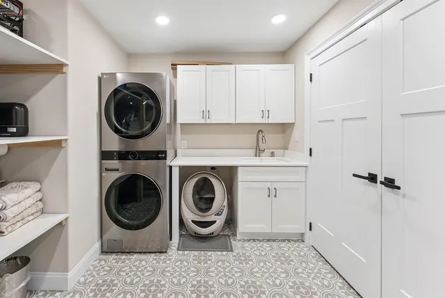 a utility room with sink dryer and washer