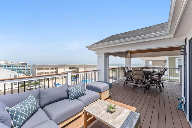 a balcony with furniture and wooden floor
