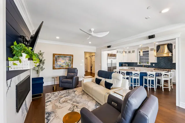 a living room with furniture a dining table and a fireplace