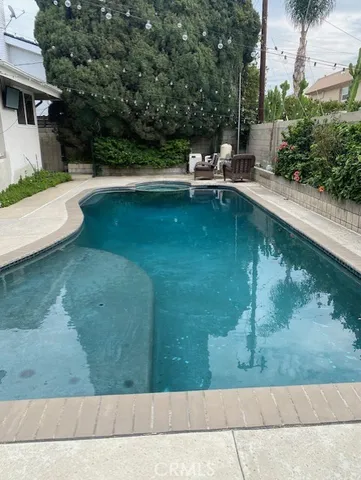 a view of backyard with swimming pool