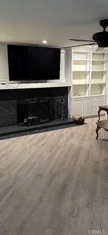 a living room with a fireplace and a flat screen tv