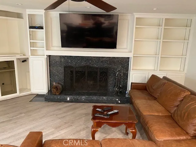 a living room with furniture a flat screen tv and a fireplace