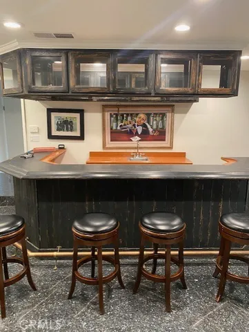 a outdoor dining space with furniture and a wooden floor