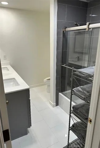 a bathroom with a shower and a sink