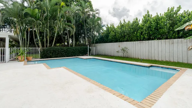 a view of a house with yard and a tree