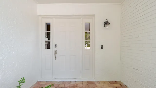 a view of staircase with wooden floor and white walls