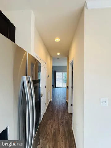 a view of a refrigerator in kitchen and wooden floor