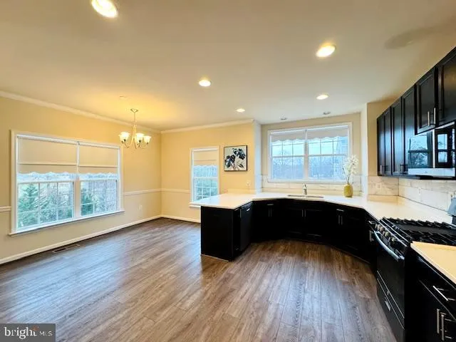 a large kitchen with wooden floors and wooden cabinets