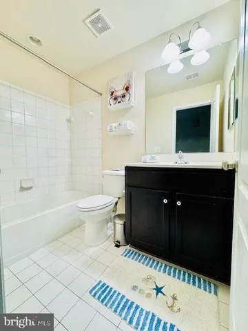a bathroom with a sink a toilet a mirror and shower