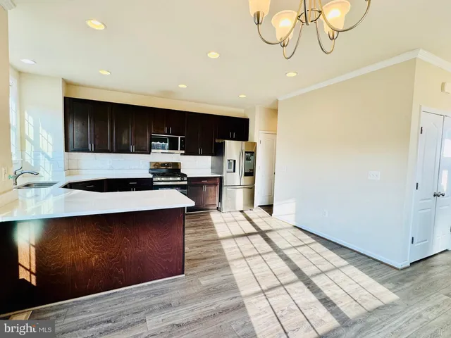 a kitchen with stainless steel appliances a microwave a stove and a refrigerator