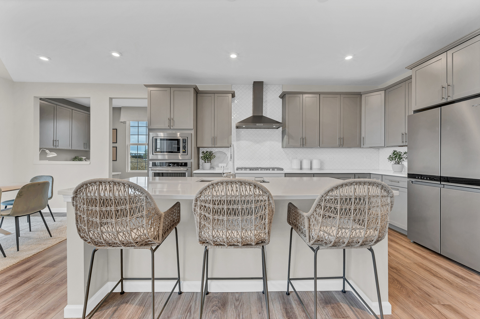 12570 Eileen Street Lemont, IL 60439 - Photo 3 of 17 a kitchen with stainless steel appliances granite countertop a table chairs and a refrigerator