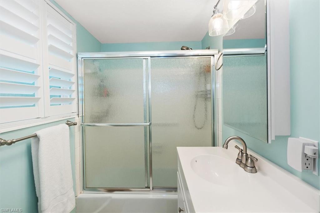 291A 8th Avenue South, Unit 291A Naples, FL 34102 - Photo 18 of 25 Full bathroom with combined bath / shower with glass door and vanity