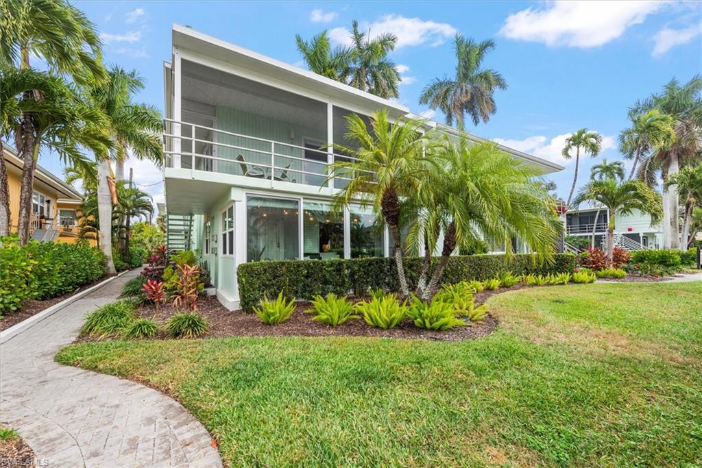 291A 8th Avenue South, Unit 291A Naples, FL 34102 - Photo 4 of 25 View of front of home with enclosed lanai and front lawn
