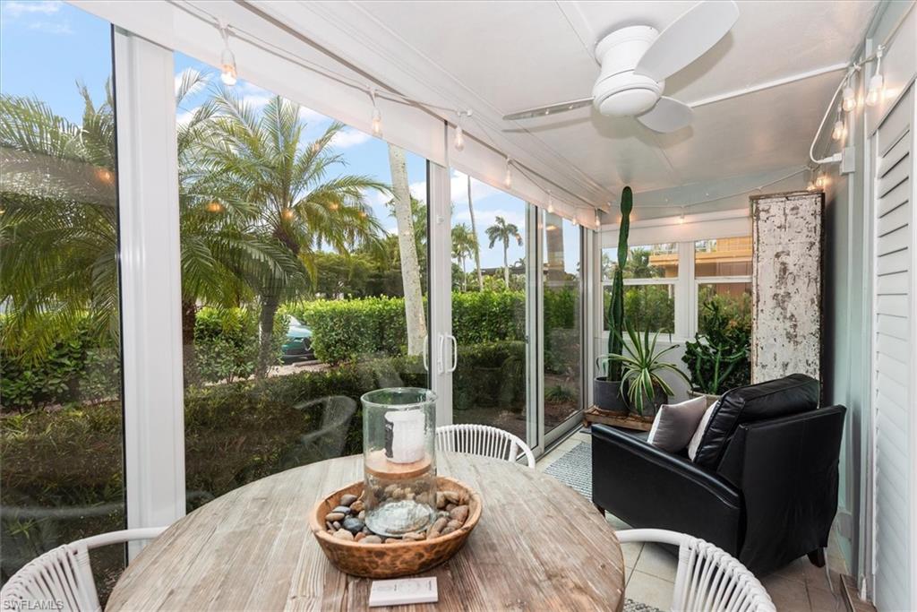291A 8th Avenue South, Unit 291A Naples, FL 34102 - Photo 8 of 25 Sunroom with tile patterned floors, roll-down shades and alfresco dining