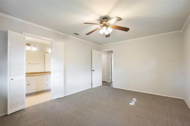 a bathroom with a granite countertop double vanity sink a mirror and a toilet