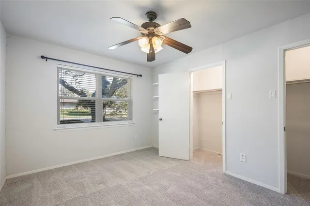 a bathroom with a granite countertop sink a toilet and a shower