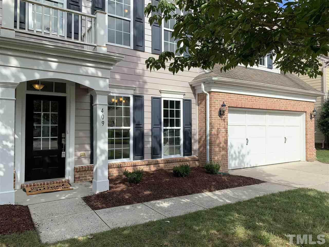 409 Amiable Loop Cary, NC 27519 - Photo 1 of 3 a front view of a house with a yard