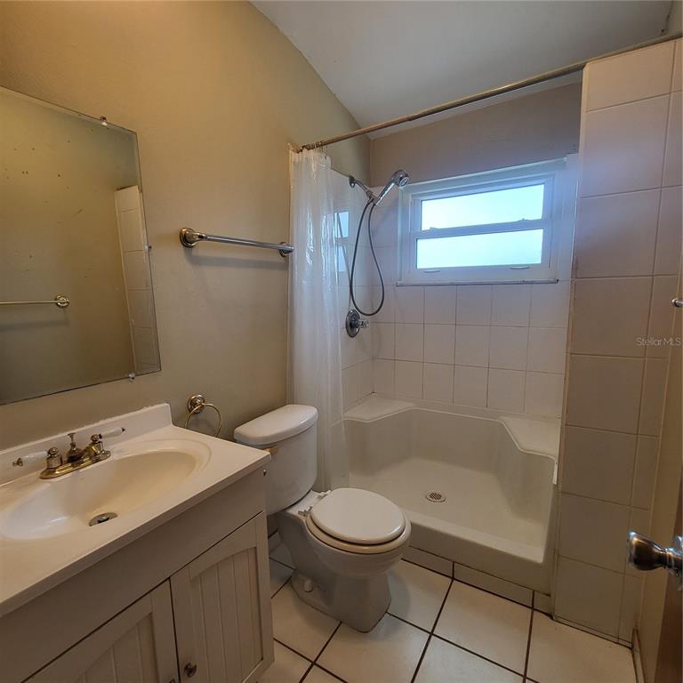 911 Washington Avenue Southwest, Unit 306 Largo, FL 33770 - Photo 14 of 14 a bathroom with a sink a toilet and shower