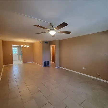 a view of an empty room with a ceiling fan
