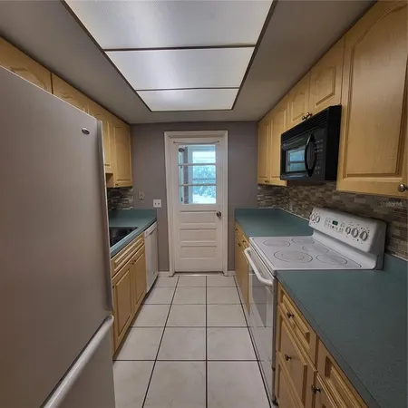 a kitchen with a sink a stove and cabinets