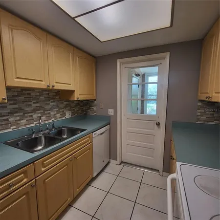 a kitchen that has a sink and cabinets