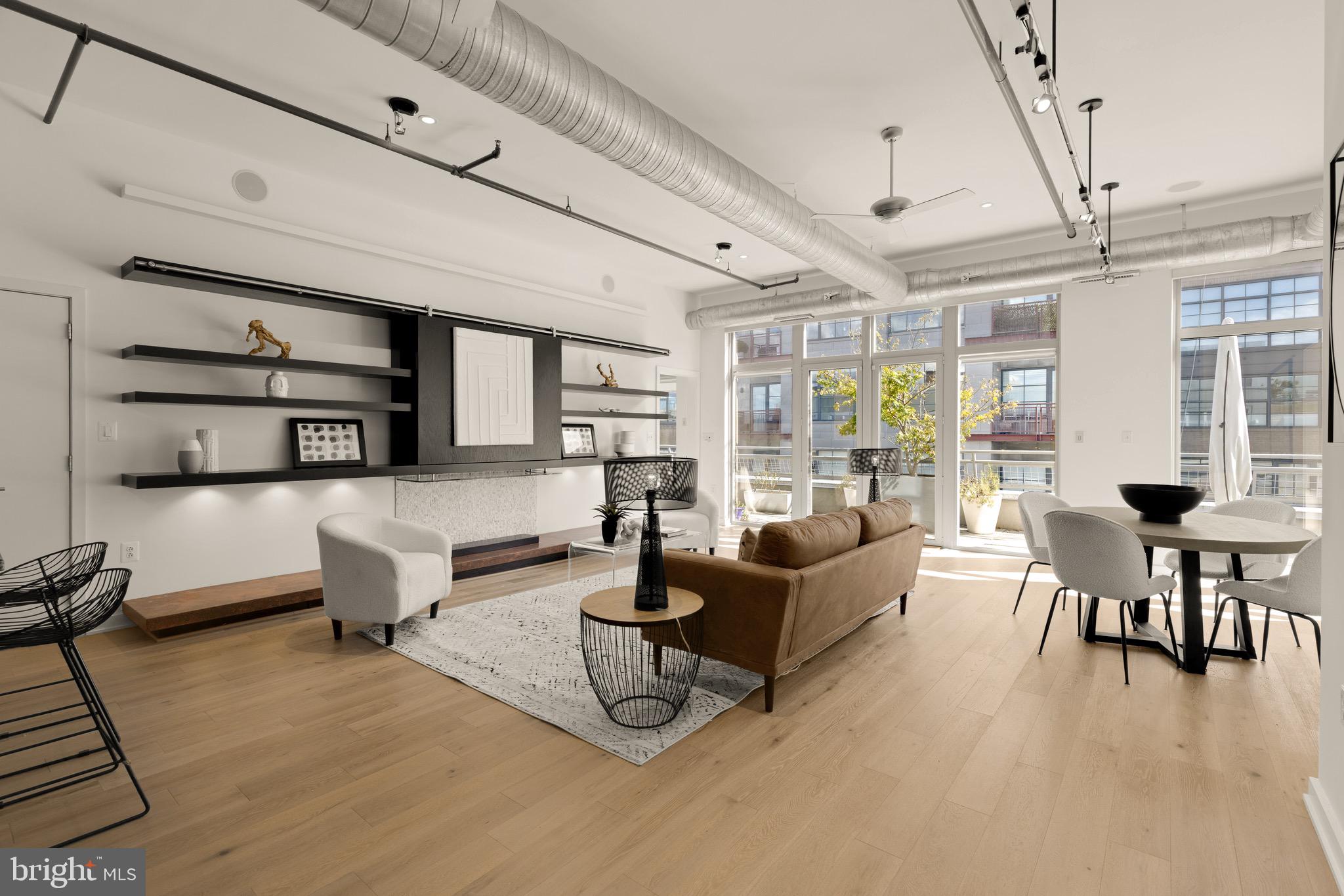 a living room with furniture wooden floor and dining table