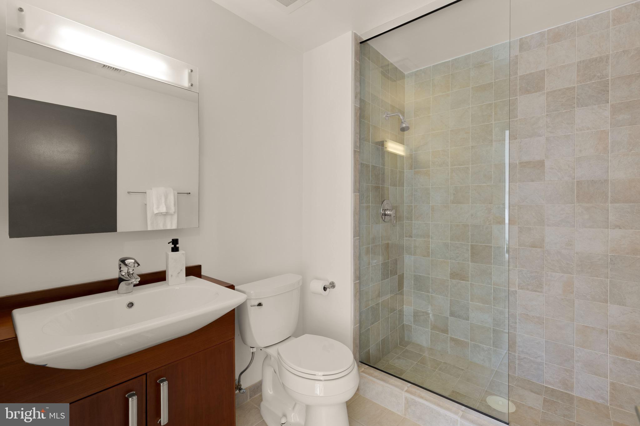 1401 Church Street Northwest, Unit 523 Washington, DC 20005 - Photo 18 of 27 a bathroom with a sink toilet and shower