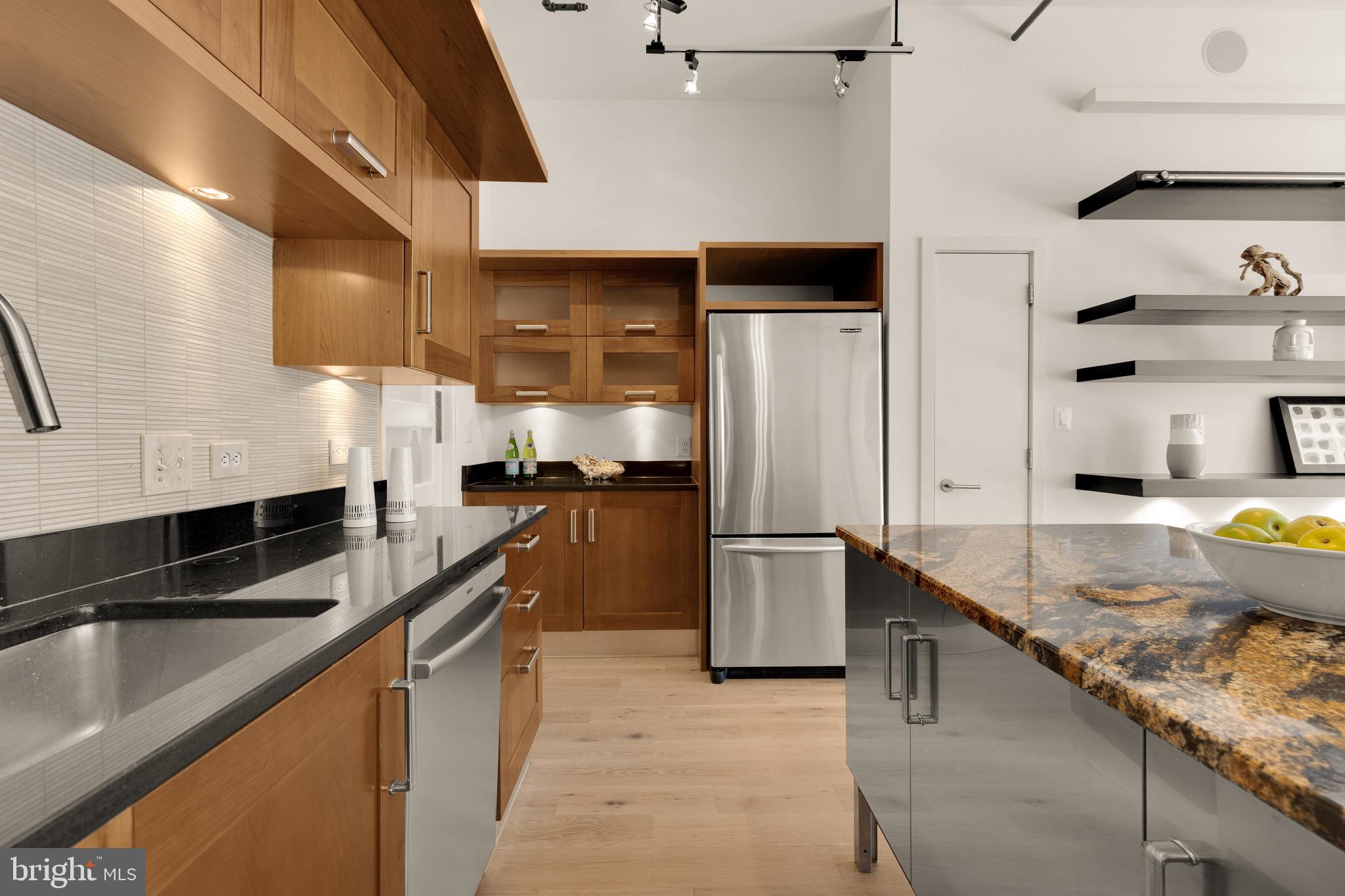 1401 Church Street Northwest, Unit 523 Washington, DC 20005 - Photo 6 of 27 a kitchen with stainless steel appliances granite countertop a sink a stove and a refrigerator