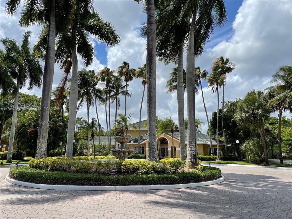 3985 West McNab Road, Unit A101 Pompano Beach, FL 33069 - Photo 11 of 13 front view of a house with a palm tree