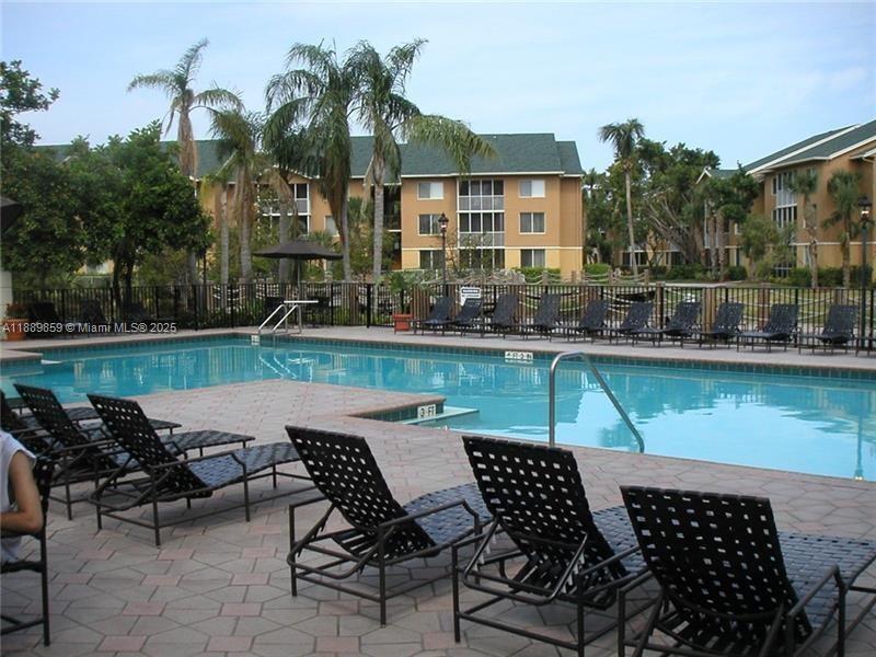 3985 West McNab Road, Unit A101 Pompano Beach, FL 33069 - Photo 12 of 13 a view of a chairs and table in the terrace