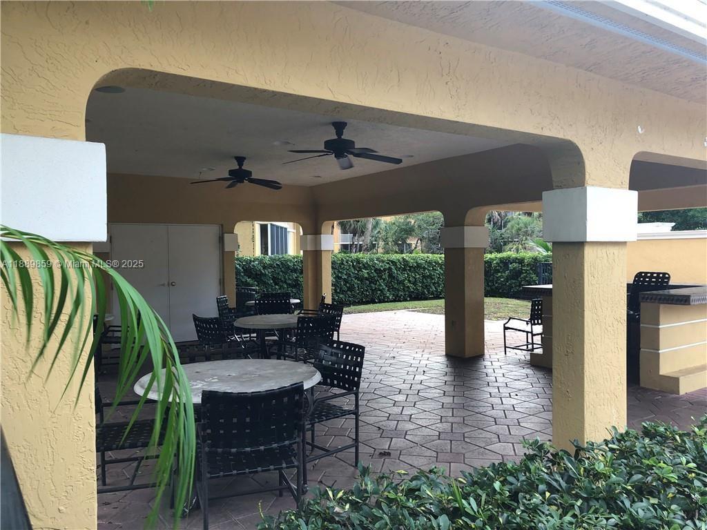 3985 West McNab Road, Unit A101 Pompano Beach, FL 33069 - Photo 13 of 13 a view of a porch with chairs and backyard