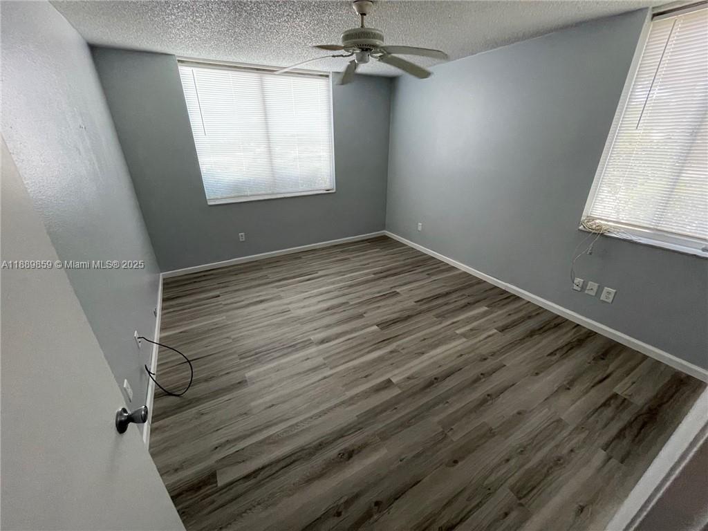 3985 West McNab Road, Unit A101 Pompano Beach, FL 33069 - Photo 4 of 13 an empty room with windows