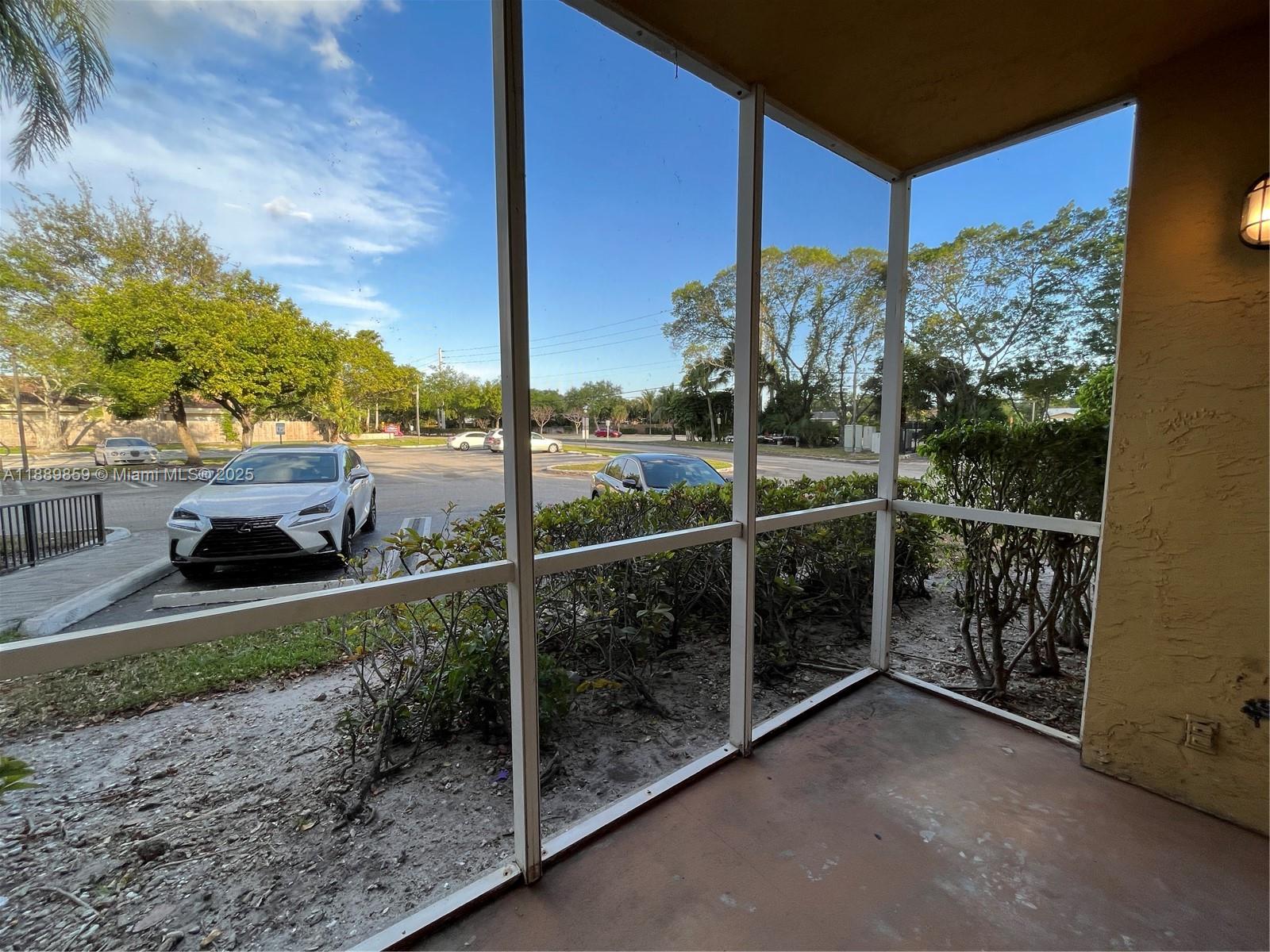 3985 West McNab Road, Unit A101 Pompano Beach, FL 33069 - Photo 8 of 13 a view of a balcony with floor to ceiling windows and a table