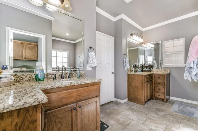 a bathroom with a sink double vanity and a mirror
