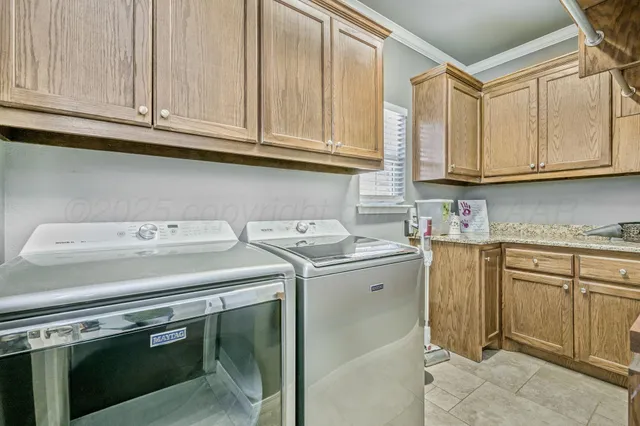 a utility room with stainless steel appliances granite countertop a sink and a stove