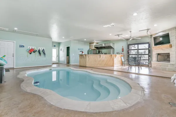 a view or kitchen island with stainless steel appliances refrigerator