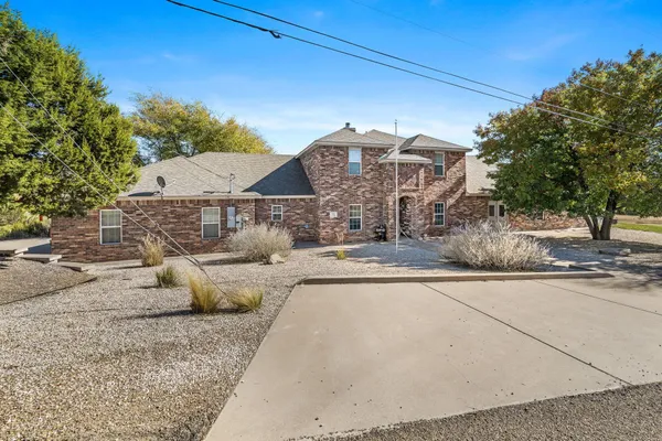 a view of a white house with a outdoor space
