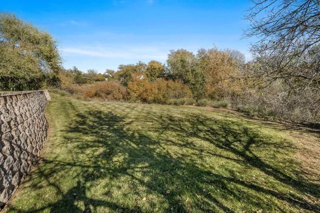 a view of a patio with table and chairs with wooden floor and fence