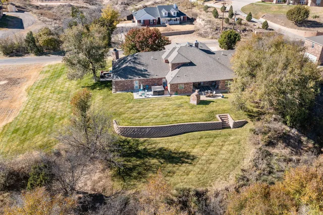 an aerial view of a house with a yard