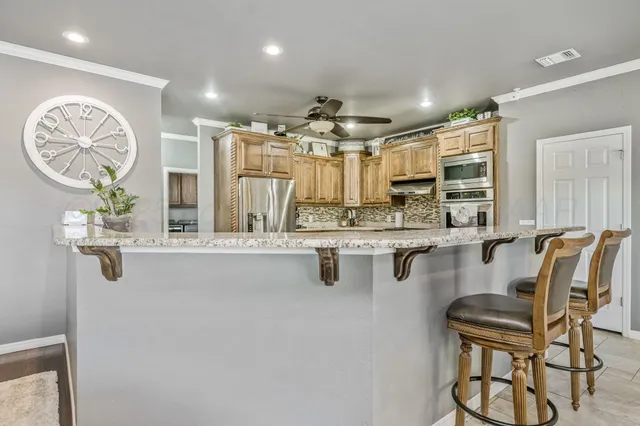 a kitchen with center island table and chairs