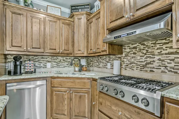 a white stove top oven sitting inside of a kitchen