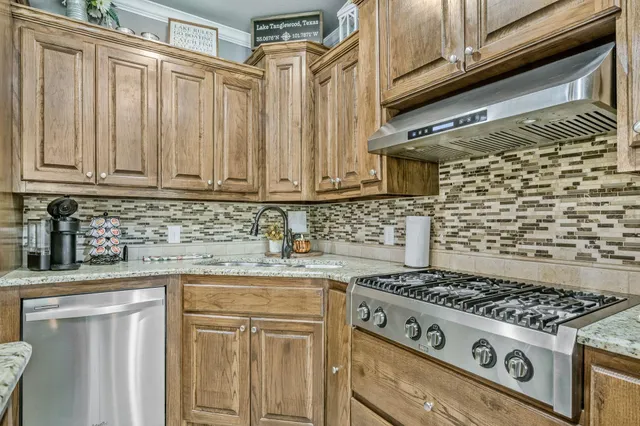 a white stove top oven sitting inside of a kitchen
