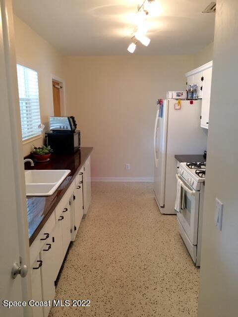 700 Espanola Way Melbourne, FL 32901 - Photo 4 of 15 a kitchen with refrigerator and window