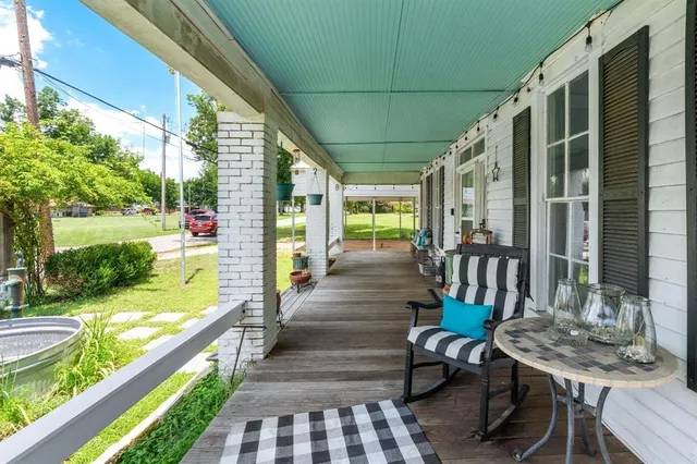 a view of a patio with table and chairs and wooden floor
