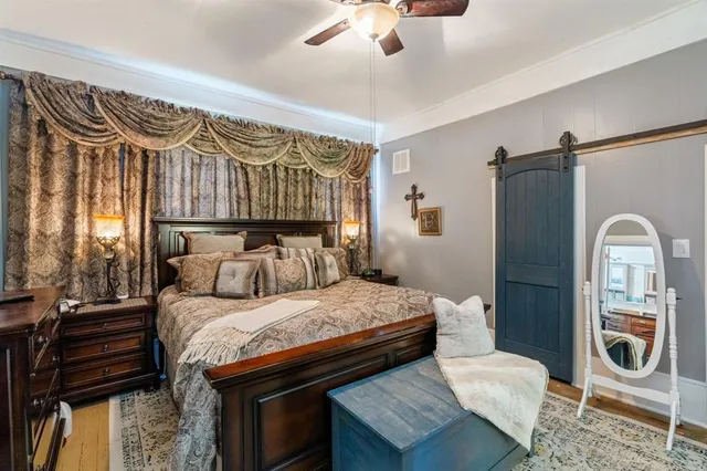 a bedroom with a bed and a chandelier