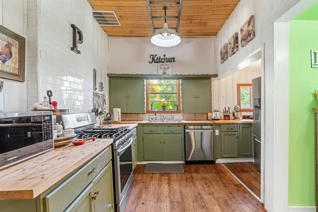 a kitchen with stainless steel appliances granite countertop a stove and a sink
