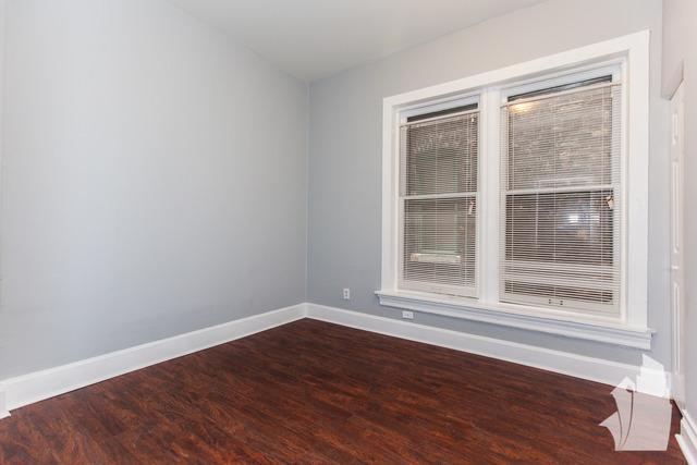 Undisclosed Address Chicago, IL 60614 - Photo 12 of 18 a view of an empty room with wooden floor and a window