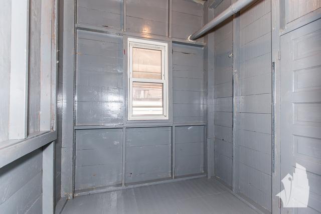 Undisclosed Address Chicago, IL 60614 - Photo 18 of 18 a bathroom with a shower and a window